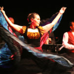 Female band member dancing on stage